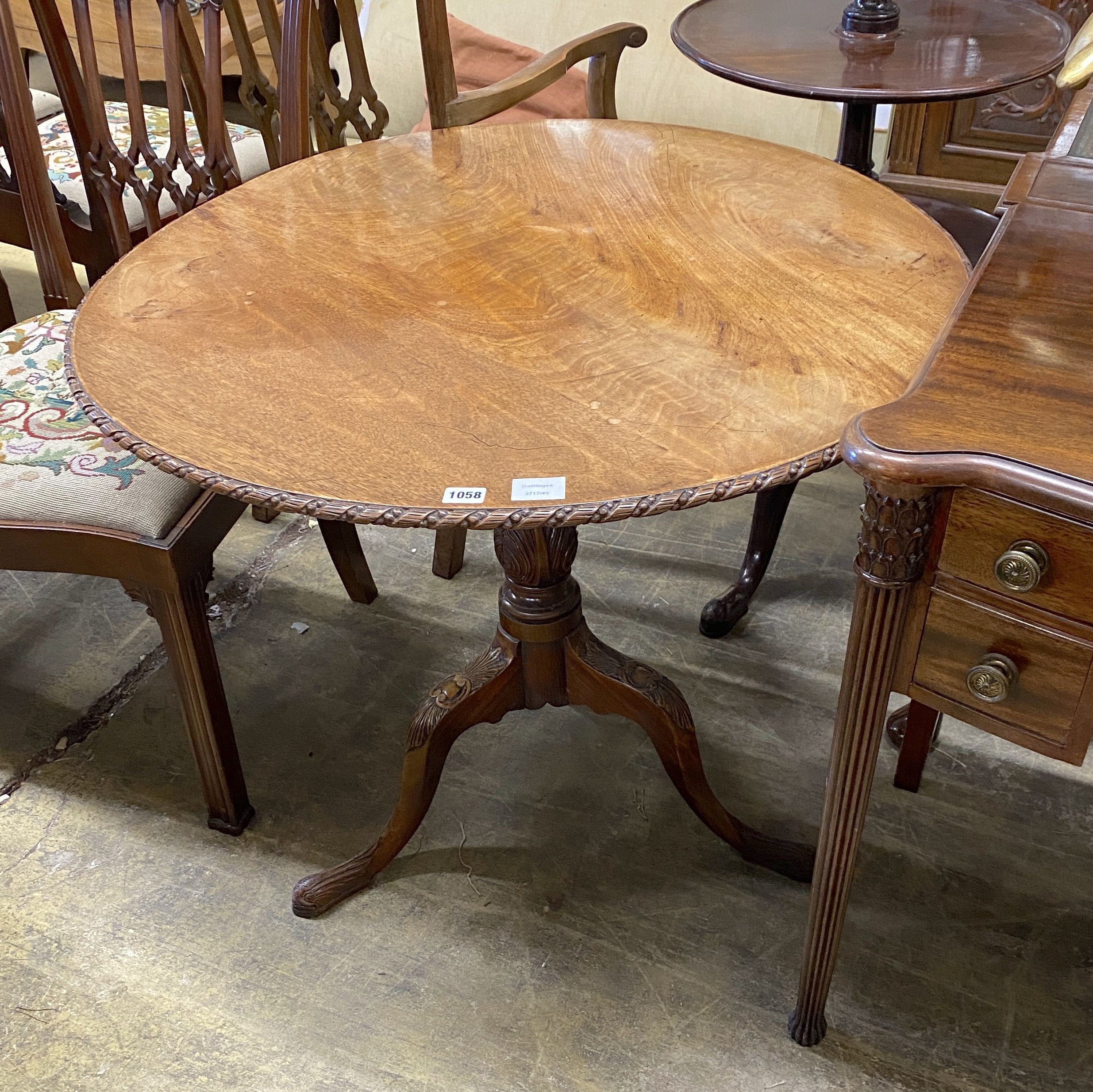 A George III carved circular mahogany tilt top tea table, diameter 88cm, height 71cm